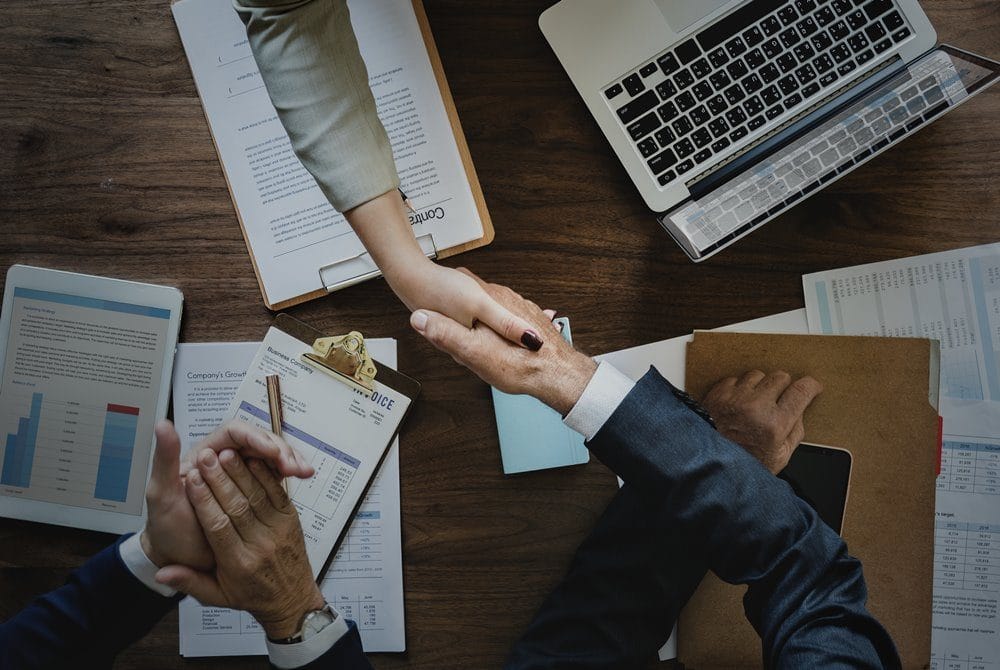 Business people shaking hands together